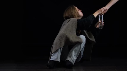 Alcoholic female suffering withdrawal symptoms, taking greedily bottle of vodka