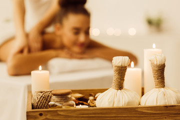 Fototapeta na wymiar Aroma spa composition with candles and relaxing woman