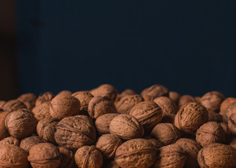 unshelled walnuts close up on black background with copy space