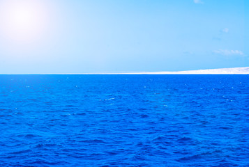 Fototapeta na wymiar Calm Sea Ocean And Blue Sky Background