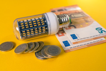 Led Light Bulb and european banknotes and coins. E27 Corn bulb.