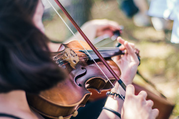 The girl plays mentally and beautifully on the violin close-up