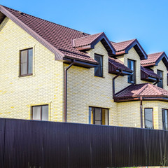 Obraz premium The house with plastic windows and a roof of corrugated sheet. R