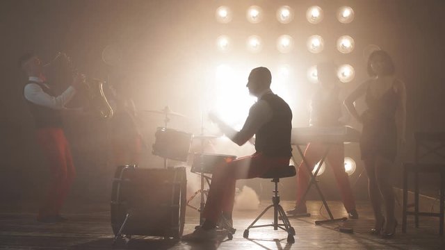 Elegant drummer performing with friends in the cabarets. Free time