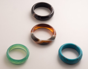 Four rings of colored stone on a white background