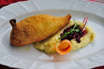 Côtelette de volaille (Kiev style chicken cutlet) served with mashed potatoes and cowberry sauce in Moscow, Russia