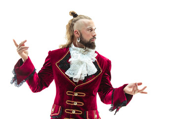 The young man wearing a traditional medieval costume of marquis posing at studio. Fantasy, Antique,...