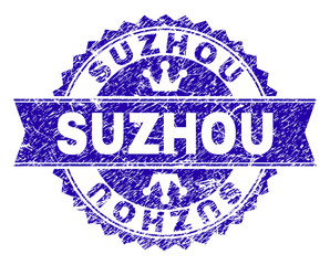 SUZHOU rosette stamp overlay with distress texture. Designed with round rosette, ribbon and small crowns. Blue vector rubber watermark of SUZHOU title with dirty texture.