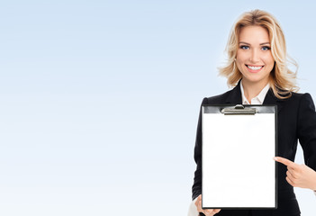 Fototapeta premium young businesswoman showing blank clipboard