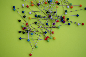Colorful pins against green background
