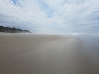 Fototapeta na wymiar ocean water and sand at the beach in Newport, Oregon