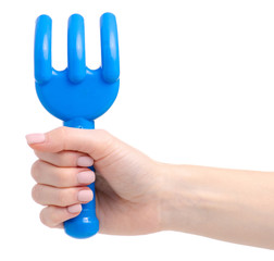 Baby blue rake sandbox toys in hand on a white background isolation