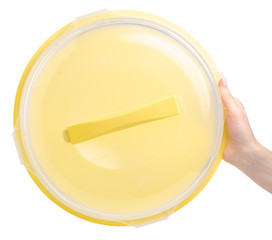 Plastic cake bowl plastic yellow in hand on a white background. Isolation
