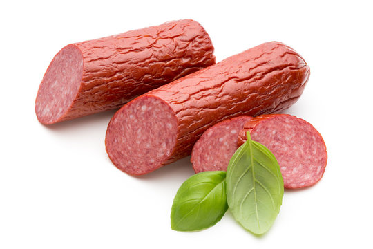 Salami smoked sausage, basil leaves on white background cutout.