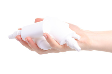 White bottles nose spray in hand on white background isolation