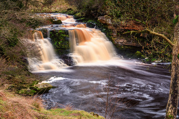 Waterfall at Crammel Linn, as the River Irthing flows over the 10 metre falls it marks the boundary between Northumberland and Cumbria just north of Gilsland, England