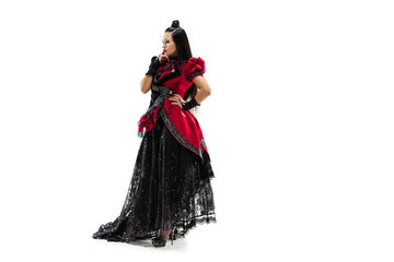Fototapeta premium The young woman dressed in medieval style posing at studio as marquise. Fantasy, Antique, Renaissance concept