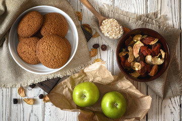 Obraz na płótnie Canvas Wholesome breakfast. Homemade oatmeal cookies, apples and dried fruits.