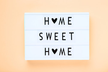 Lightbox with words Sweet Home on beige background