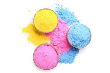Colorful holi powder in bowls on white background