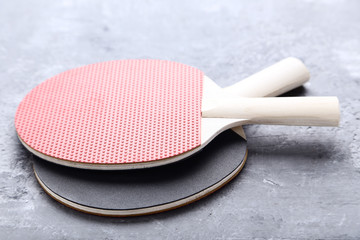 Table tennis rackets on grey wooden table