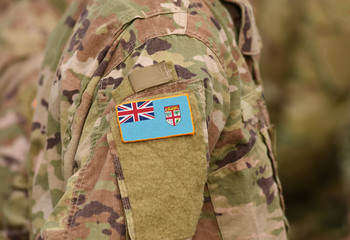 Flag of Fiji on soldiers arm. Flag of Fiji on military uniforms (collage).