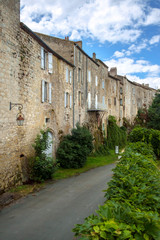 Fototapeta na wymiar The massive walls of historic homes in the 'bastide' town of Tournon d'Agenais, Lot et Garonne, France