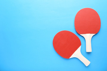 Table tennis rackets on blue background