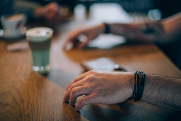 Tattooed male hands gesticulating while talking