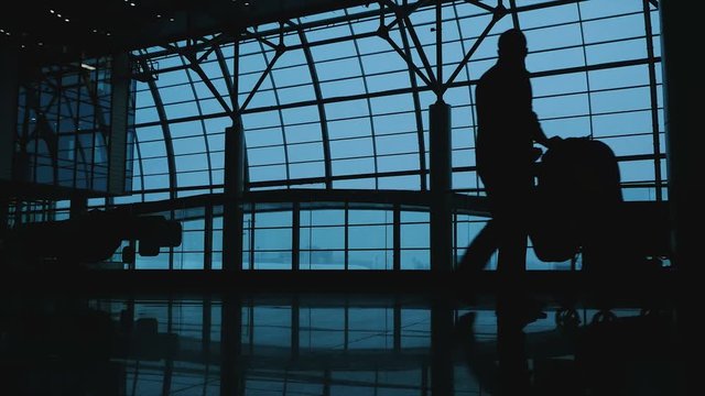 Father with sidecar and a small child go at the airport. Silhouette