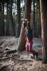 Teen boy at bungee in autumn forest in beauty sunny day