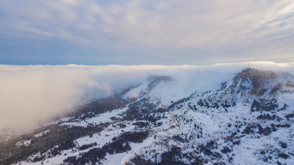 Aerial view of clouds above mountains. Picturesque and gorgeous scene.