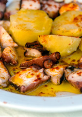 Octopus with potatoes served on a plate