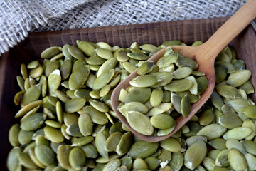 Pumpkin seeds in wooden plate  Healthy organic food