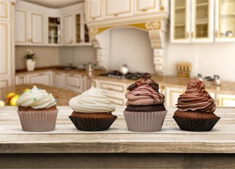 Tasty Colorful cupcakes on background