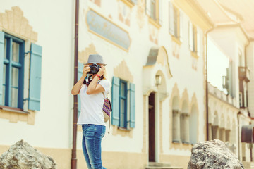 Fototapeta premium Young female tourist photographer. Having a great vacation in Germany
