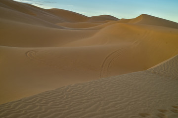 Fototapeta na wymiar sunrise walk in sand dunes, Imperial Sand Dunes, California, USA