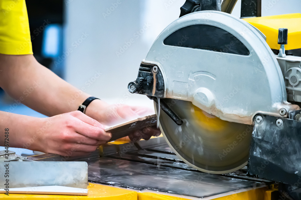 Poster a circular saw. worker cut the tile. tiled work. facing work. tool for finishing work. circular saw.