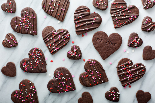Chocolate hearts cookies for Valentines day with glaze and sprinkles overhead shot
