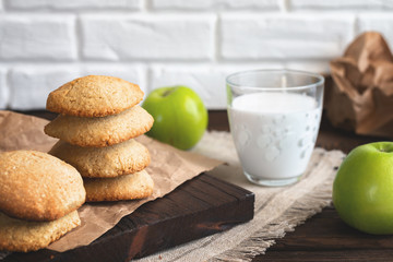 Daily healthy breakfast. Homemade oatmeal cookies, milk, fruit on dark  background.