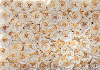 a wall of white paper flowers preparing for the holiday
