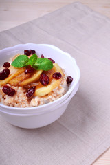 Porridge with caramelized apples and dried cranberries 