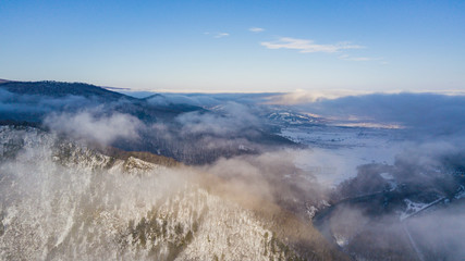 Aerial view of clouds above mountains. Picturesque and gorgeous scene.