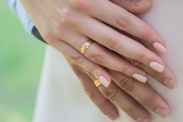 wedding rings. Newly wed couple's hands with wedding rings. Bride and groom's hands with wedding rings.