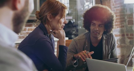 Colleagues and clients talking strategy with laptop and tablet.Group of multiethnic people having informal business team meeting in restaurant lounge.Teamwork,corporate,diversity and social concepts - Powered by Adobe