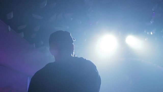 young man is reading rap on the stage. A Young Man Under The Spotlight With The Rap Scene