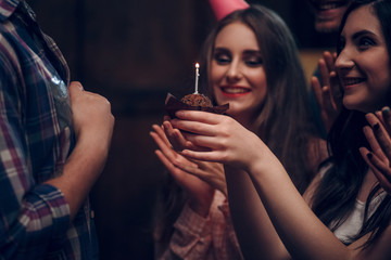 Tasty birthday brown cupcake with candle