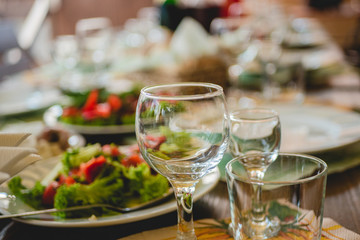 healthy eating, dieting, vegetarian kitchen and cooking concept - close up of vegetable salad bowl and fork at home. Stemware