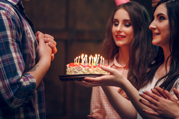 Young woman giving birthday cake