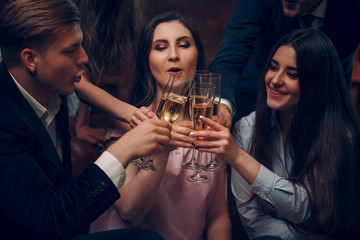 Merry frinds celebrate birthday and cheers with a glasses of champagne